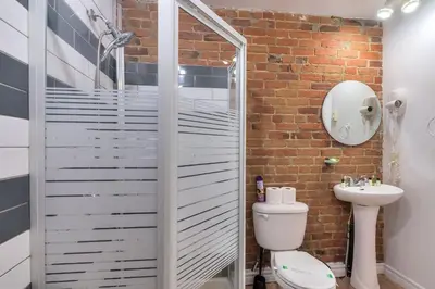 a bathroom with a shower and a toilet and a sink at Fox Aparthotel 9 min of Palais Des Congres II in Montréal