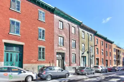 a group of cars parked in front of a large brick building at Fox Aparthotel 9 min of Palais Des Congres II in Montréal