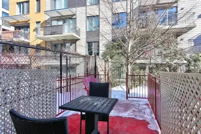 a patio with a table and chairs and a building at Fox Aparthotel Palais Des Congres III in Montréal