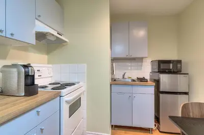 a kitchen with white cabinets and a white appliances at Fox Aparthotel Palais Des Congres III in Montréal