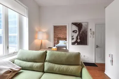 a living room with a couch and a bed at Fox Aparthotel Palais Des Congres IV in Montréal