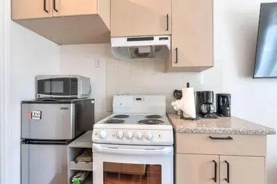 a kitchen with a white stove and a microwave at Fox Aparthotel Palais Des Congres IV in Montréal