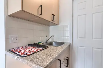 a kitchen with a sink and a counter top at Fox Aparthotel Palais Des Congres IV in Montréal