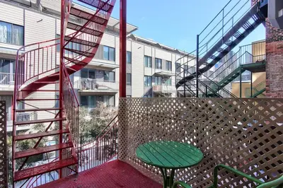 a stair case and a green table in a balcony at Fox Aparthotel Palais Des Congres IV in Montréal