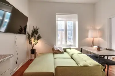 a living room with a couch and a table at Fox Aparthotel Palais Des Congres IV in Montréal