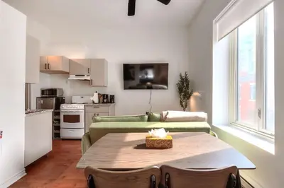 a living room with a table and a couch at Fox Aparthotel Palais Des Congres IV in Montréal