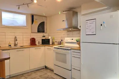 a kitchen with white appliances and a white refrigerator at Private Charming Twin Room & Parking in Saint-Bruno-de-Montarville