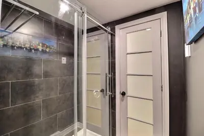 a shower with a glass door in a bathroom at Private Charming Twin Room & Parking in Saint-Bruno-de-Montarville