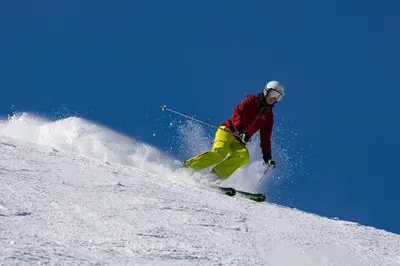 a man is skiing down a snow covered slope at Private Charming Twin Room & Parking in Saint-Bruno-de-Montarville