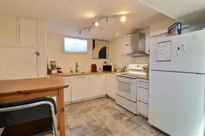a kitchen with white appliances and a white refrigerator at Private Charming Twin Room & Parking in Saint-Bruno-de-Montarville