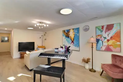 a living room with a piano and a couch at Private Peaceful Queen Room Free Parking in Saint-Bruno-de-Montarville