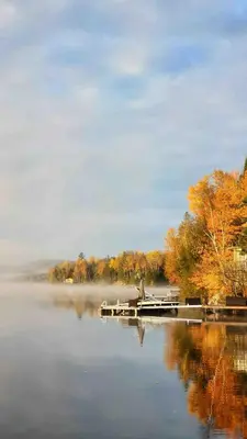 a person sitting on a dock on a lake at Private Peaceful Queen Room Free Parking in Saint-Bruno-de-Montarville