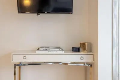 a shelf with a tv on top of it at Majestic Villa in Downtown Griffintown in Montréal