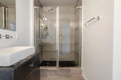a bathroom with a shower and a sink at Majestic Villa in Downtown Griffintown in Montréal