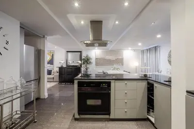 a large kitchen with a stove top oven at Majestic Villa in Downtown Griffintown in Montréal
