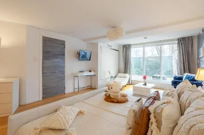a living room with a couch and a table at Majestic Villa in Downtown Griffintown in Montréal