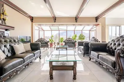 a living room with leather couches and a table at Waterfront Mansion with Mont-Saint-Hilaire Views, Near Montreal in Beloeil Village