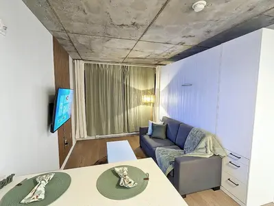 a living room with a couch and a table at Studio Chic - Centre MTL in Montréal