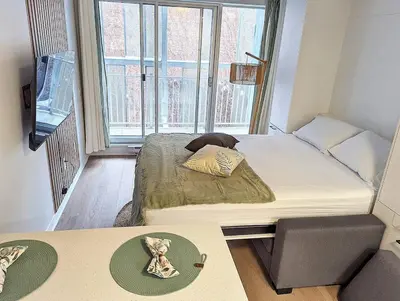 a small room with a bed and a window at Studio Chic - Centre MTL in Montréal