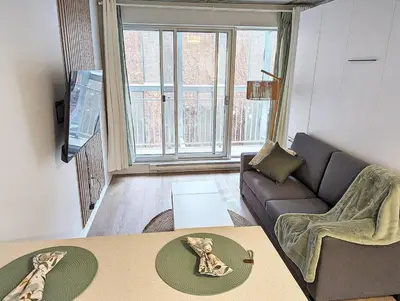 a living room with a couch and a table at Studio Chic - Centre MTL in Montréal