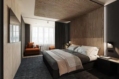 a bedroom with a large bed and a chair at SonoLux in Montréal