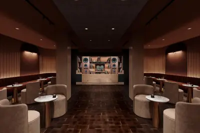 a restaurant with tables and chairs and a stage at SonoLux in Montréal