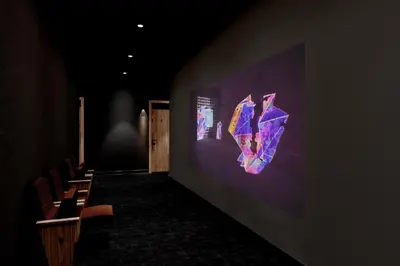 a dark room with chairs and a wall with a screen at SonoLux in Montréal