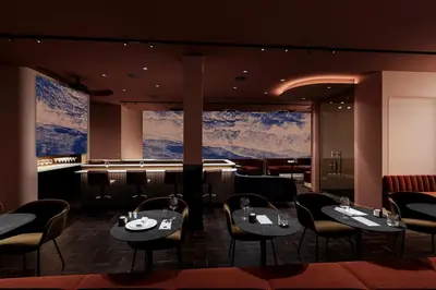 a restaurant with tables and chairs and large windows at SonoLux in Montréal