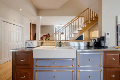 a kitchen with a sink and a staircase at Downtown Retreat with Modern Comfort in Montréal