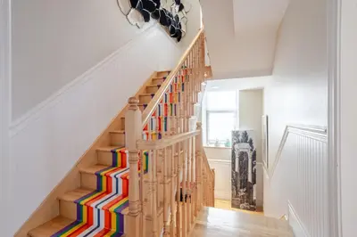 a colorful staircase in a home with white walls at Downtown Retreat with Modern Comfort in Montréal