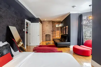 a bedroom with a bed and a fireplace at Downtown Retreat with Modern Comfort in Montréal