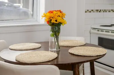 a table with a vase of flowers on top of it at Exclusive Loft Living in the Heart of Montreal in Montréal