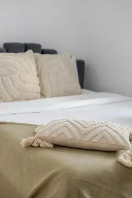 two beds with white sheets and a blanket at Exclusive Loft Living in the Heart of Montreal in Montréal