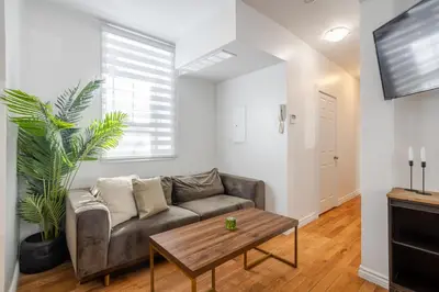 a living room with a couch and a table at Exclusive Loft Living in the Heart of Montreal in Montréal