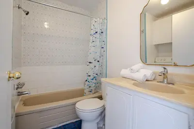 a bathroom with a sink and a toilet and a tub at Bright 2BR in Plateau Mont Royal Downtown in Montréal