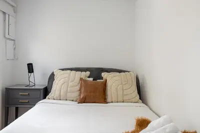 a bedroom with a bed with brown pillows at Bright 2BR in Plateau Mont Royal Downtown in Montréal