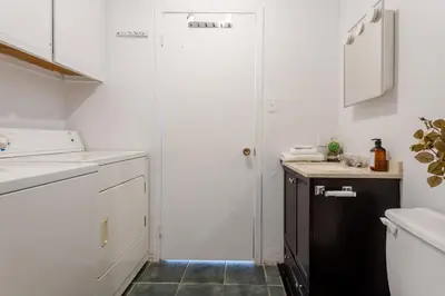 a kitchen with a white door and a sink at Stunning 2B in Plateau Mont-Royal in Montréal