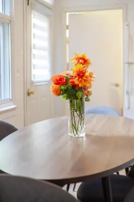 a vase of flowers sitting on top of a table at Convenient 4BR in Mont Royal Downtown in Montréal