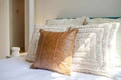 a pile of pillows sitting on top of a bed at Convenient 4BR in Mont Royal Downtown in Montréal
