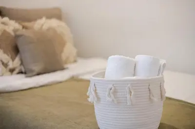 a white basket filled with toilet paper on a table at Convenient 4BR in Mont Royal Downtown in Montréal