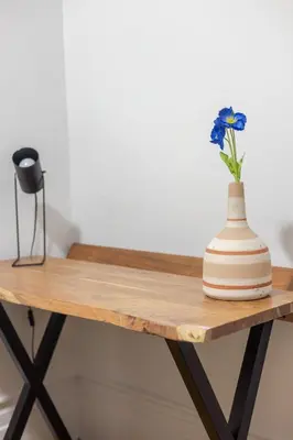 a vase sitting on top of a wooden table at Ideal 4BR Property in Downtown Montreal in Montréal