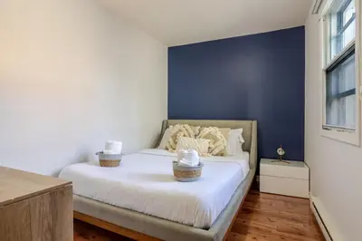 a bedroom with a bed with two baskets on it at Ideal 4BR Property in Downtown Montreal in Montréal