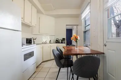 a kitchen with a wooden table and chairs at Ideal 4BR Property in Downtown Montreal in Montréal