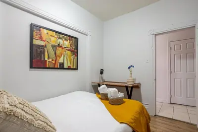 a bedroom with a bed and a painting on the wall at Ideal 4BR Property in Downtown Montreal in Montréal