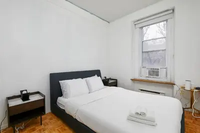 a bedroom with a large white bed and a window at Beautiful apartment in Downtown in Montréal