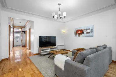 a living room with a couch and a tv at Magnificent 4BR in Downtown Mont-Royal in Montréal
