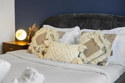 a bed with white sheets and pillows on it at Magnificent 4BR in Downtown Mont-Royal in Montréal