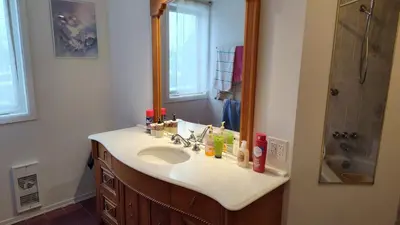 a bathroom with a sink and a mirror at Family-Friendly in Quiet Laval Neighborhood in Laval