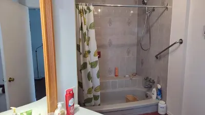 a bathroom with a shower with a shower curtain at Family-Friendly in Quiet Laval Neighborhood in Laval