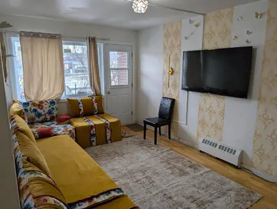 a living room with a couch and a flat screen tv at Chez Walid in Montréal